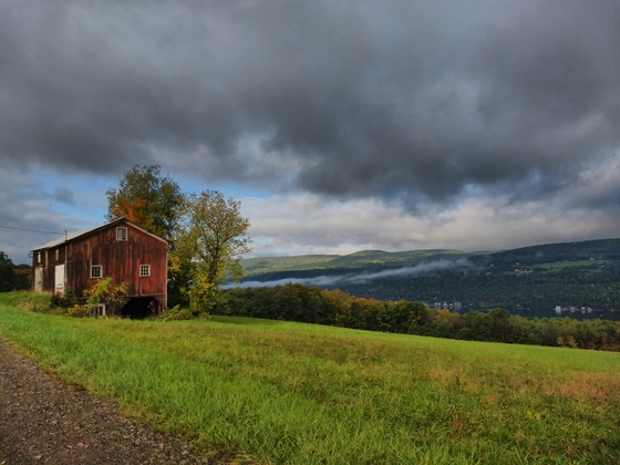 A barn and Keuka with mist on the hill